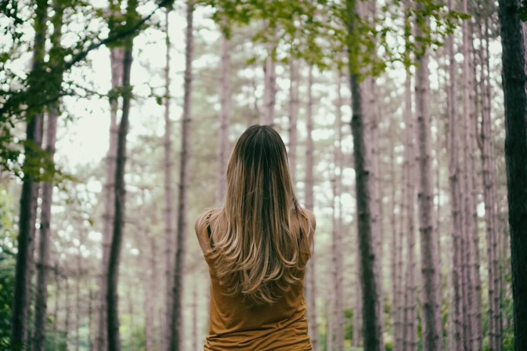 Woman Peacefully Staring Into The Forest